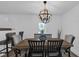 Charming dining room with a modern chandelier and wood floors at 7845 Bluff Rd, Indianapolis, IN 46217