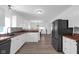 Modern kitchen featuring white cabinetry, black appliances, and butcher block countertops at 7845 Bluff Rd, Indianapolis, IN 46217