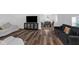 Open-concept living room with hardwood flooring flowing into dining area at 7845 Bluff Rd, Indianapolis, IN 46217