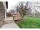 Wooden deck with a glass table and steps to the grassy backyard at 8151 Taunton Rd, Indianapolis, IN 46260
