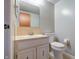 Bathroom features a vanity with sink, mirror, and toilet against light grey walls at 8151 Taunton Rd, Indianapolis, IN 46260