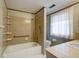 Bathroom with tub, tile surround, and large window at 8151 Taunton Rd, Indianapolis, IN 46260