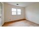 This bedroom features hardwood floors, a double-hung window, and neutral walls at 8151 Taunton Rd, Indianapolis, IN 46260
