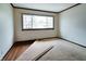 Bedroom showing carpet and hardwood flooring, large window at 8151 Taunton Rd, Indianapolis, IN 46260