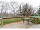 Wooden deck with a glass table and seating overlooking the backyard at 8151 Taunton Rd, Indianapolis, IN 46260