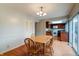 Dining area with wood table, chairs, and sliding glass doors to outdoor space. Kitchen view at 8151 Taunton Rd, Indianapolis, IN 46260