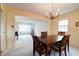 Bright dining room featuring a chandelier and easy flow to adjacent living spaces, ideal for entertaining at 8151 Taunton Rd, Indianapolis, IN 46260