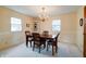 Cozy dining room with traditional chandelier, wainscoting, and views into the connected living spaces at 8151 Taunton Rd, Indianapolis, IN 46260