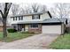 Charming two-story home with a brick and siding exterior, attached two car garage, and a well-manicured front yard at 8151 Taunton Rd, Indianapolis, IN 46260