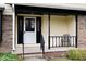 Inviting front porch with black rails and a decorative storm door offers a cozy spot to relax at 8151 Taunton Rd, Indianapolis, IN 46260