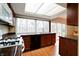 Bright kitchen with stainless appliances, wood cabinets, and a large window overlooking the backyard at 8151 Taunton Rd, Indianapolis, IN 46260