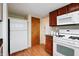 Kitchen with white appliances and wood cabinets at 8151 Taunton Rd, Indianapolis, IN 46260