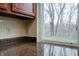 Corner of a kitchen features granite countertops, and a view from the window at 8151 Taunton Rd, Indianapolis, IN 46260