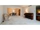 Spacious living room featuring plush carpeting, neutral walls, and seamless transition into the dining area at 8151 Taunton Rd, Indianapolis, IN 46260