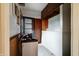 Utility room with cabinets, pegboard, a door, and a water softener at 8151 Taunton Rd, Indianapolis, IN 46260