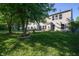 Expansive backyard with established trees, lush lawn, and a patio perfect for outdoor enjoyment at 10309 Buckshire Ln, Indianapolis, IN 46234