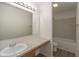 Well-lit bathroom featuring a vanity with marble countertop and tiled shower/tub at 10309 Buckshire Ln, Indianapolis, IN 46234