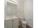 Bright powder room featuring white vanity, mirror, and toilet with modern fixtures at 10309 Buckshire Ln, Indianapolis, IN 46234