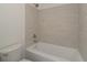 Elegant bathroom with tiled shower over tub and neutral color scheme at 10309 Buckshire Ln, Indianapolis, IN 46234