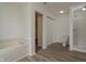 Bright bathroom featuring a bath tub, closet, toilet and laminate wood flooring at 10309 Buckshire Ln, Indianapolis, IN 46234