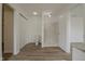 Bathroom with toilet, marble shower and closet featuring laminate wood flooring at 10309 Buckshire Ln, Indianapolis, IN 46234