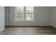 This bedroom has modern flooring, neutral walls, and a large window at 10309 Buckshire Ln, Indianapolis, IN 46234