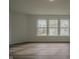 Spacious bedroom with three windows letting in plenty of natural light and laminate wood flooring at 10309 Buckshire Ln, Indianapolis, IN 46234