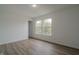 This comfortable bedroom features wood flooring and a large window at 10309 Buckshire Ln, Indianapolis, IN 46234