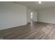 An airy bedroom featuring an open door frame and beautiful laminate wood flooring at 10309 Buckshire Ln, Indianapolis, IN 46234