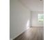 A bright and airy room, with modern flooring and a large window providing plenty of natural light at 10309 Buckshire Ln, Indianapolis, IN 46234
