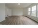 Bright bedroom with a door, two windows, and laminate wood flooring at 10309 Buckshire Ln, Indianapolis, IN 46234