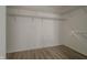 Walk-in closet with wood laminate flooring at 10309 Buckshire Ln, Indianapolis, IN 46234