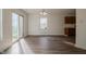 Open dining area featuring sliding glass door and wood-look flooring with view into the kitchen at 10309 Buckshire Ln, Indianapolis, IN 46234