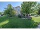 View of the front lawn, beautiful landscaping, and a two-story home in a peaceful neighborhood at 10309 Buckshire Ln, Indianapolis, IN 46234