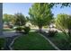 Green front yard with landscaped beds, mature trees, and inviting curb appeal at 10309 Buckshire Ln, Indianapolis, IN 46234