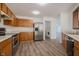 Spacious kitchen with stainless steel appliances and a view of the laundry room and open living space at 10309 Buckshire Ln, Indianapolis, IN 46234