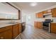 Well-lit kitchen with stainless steel appliances, light countertops, and wood cabinets at 10309 Buckshire Ln, Indianapolis, IN 46234