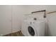 Bright laundry area features washer, dryer, shelving, and neutral walls at 10309 Buckshire Ln, Indianapolis, IN 46234