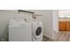 Functional laundry area with modern washer and dryer adjacent to kitchen at 10309 Buckshire Ln, Indianapolis, IN 46234