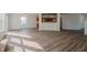 View of the living room featuring wood-look flooring, fireplace, and a view into the kitchen at 10309 Buckshire Ln, Indianapolis, IN 46234
