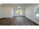 Bright living room with hardwood floors, freshly painted walls, a ceiling light, and a welcoming front door at 10309 Buckshire Ln, Indianapolis, IN 46234