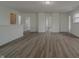 Open-concept living space with neutral walls, wood-look flooring, and multiple doorways at 10309 Buckshire Ln, Indianapolis, IN 46234