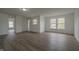 Bright living room boasts neutral walls, wood-look flooring, and natural light at 10309 Buckshire Ln, Indianapolis, IN 46234