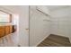 Walk-in pantry features wire shelving and wood-look floors; kitchen in background at 10309 Buckshire Ln, Indianapolis, IN 46234