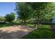 Brick patio featuring lush grass and mature shade trees, a backyard oasis for relaxation and entertainment at 10309 Buckshire Ln, Indianapolis, IN 46234