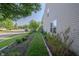Well maintained side yard with landscaped beds, healthy green grass, and mature trees at 10309 Buckshire Ln, Indianapolis, IN 46234