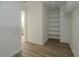 Bright walk-in closet with wood floor, adjustable shelving and rods for optimal storage solutions at 10309 Buckshire Ln, Indianapolis, IN 46234