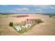 Stunning aerial view of a farm showcasing a classic red barn, multiple silos, and a traditional farmhouse nestled in a vast field at 10573 W 550 N, Thorntown, IN 46071