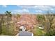 Aerial view of a brick house nestled among mature trees on a beautiful property with lush greenery at 10573 W 550 N, Thorntown, IN 46071