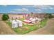 Scenic aerial shot of a red barn with silos, complemented by a charming farmhouse and verdant surroundings at 10573 W 550 N, Thorntown, IN 46071